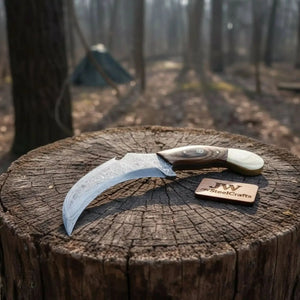Handmade damascus steel knife with premium handle on dark surface