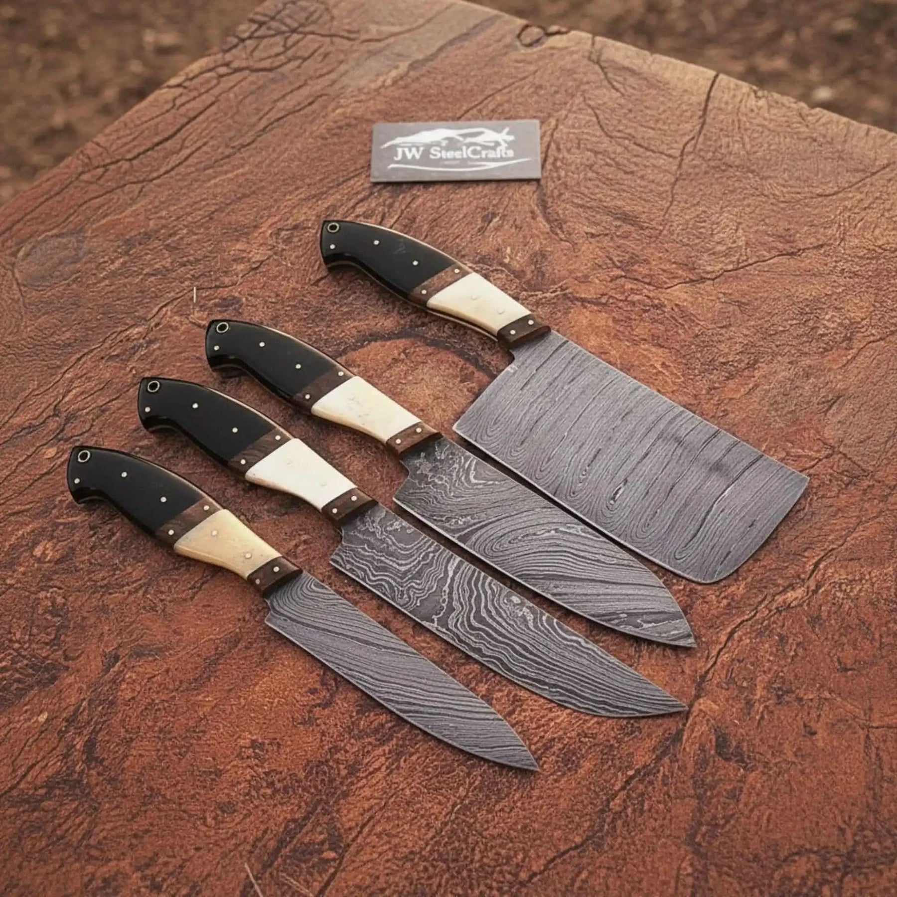 Handmade damascus steel knife with wood handle on dark surface