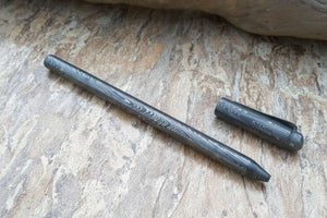 Handmade damascus steel knife with premium handle on dark surface