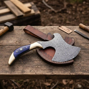 Damascus steel axe head with wood handle on rustic wood surface