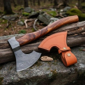 Damascus steel axe head with wood handle on rustic wood surface