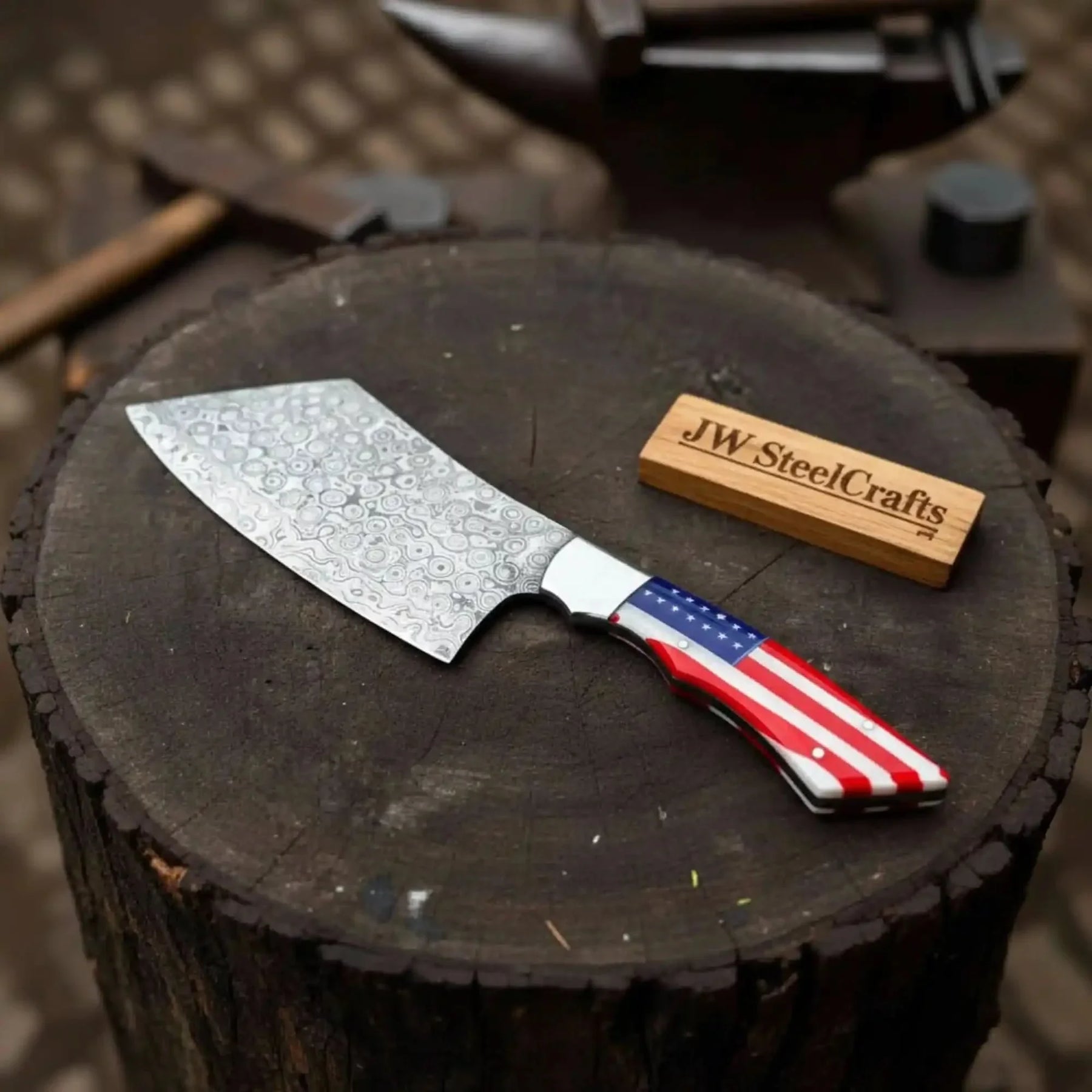 Handmade damascus steel knife with resin handle on dark surface