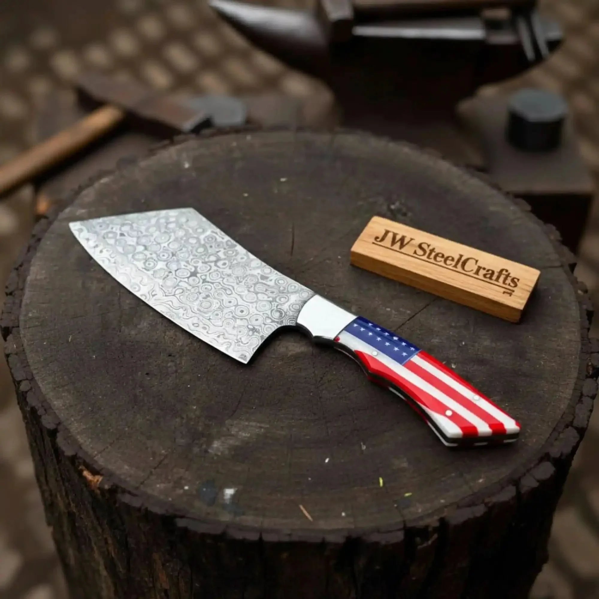 Handmade damascus steel knife with resin handle on dark surface
