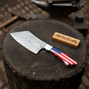 Handmade damascus steel knife with resin handle on dark surface