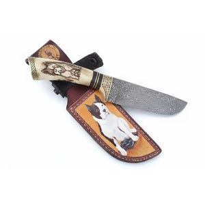 Handmade damascus steel knife with bone handle on dark surface