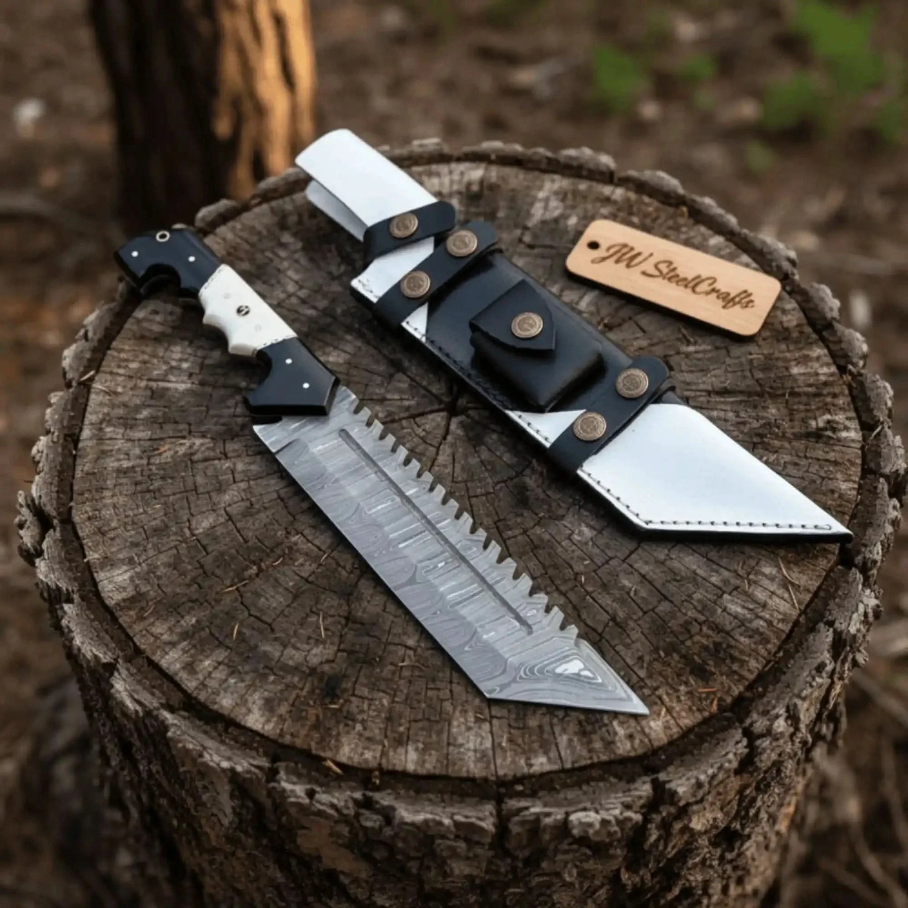 Handmade damascus steel knife with bone handle on dark surface