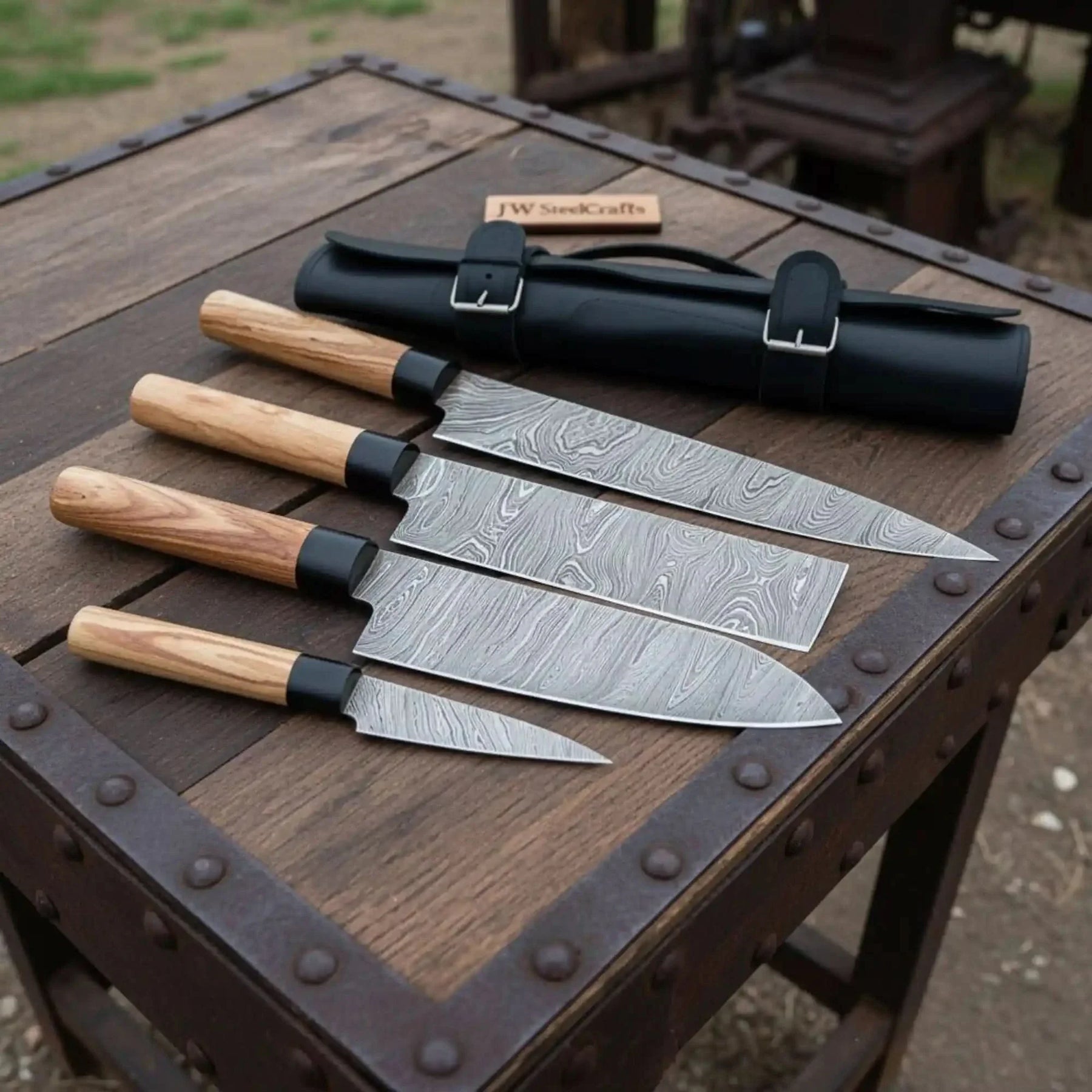 Handmade damascus steel knife with wood handle on dark surface