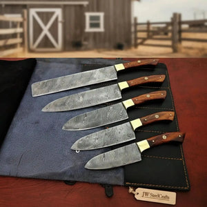 Handmade damascus steel knife with wood handle on dark surface