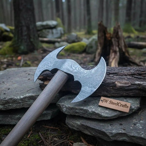Damascus steel axe head with wood handle on rustic wood surface