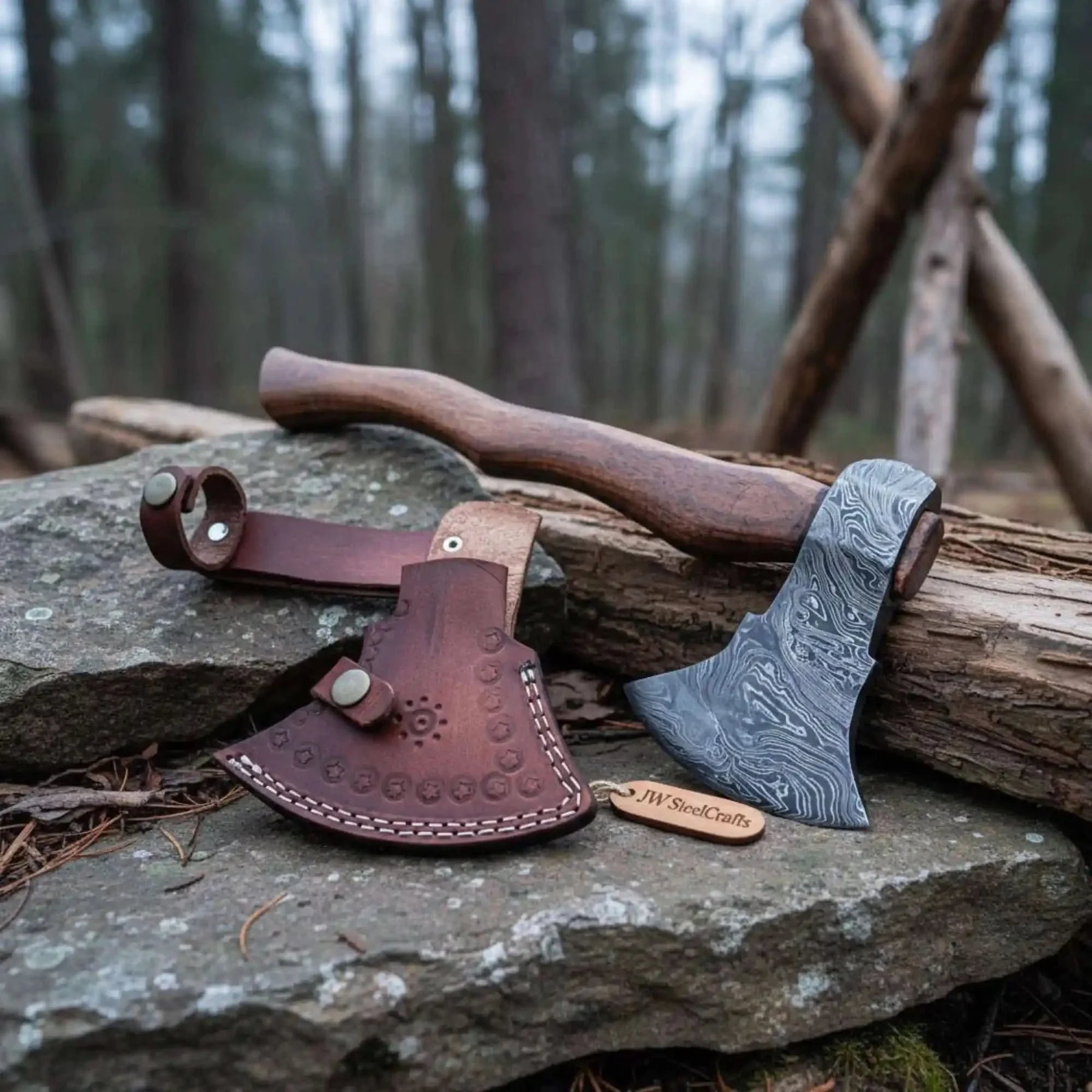 Damascus steel axe head with wood handle on rustic wood surface