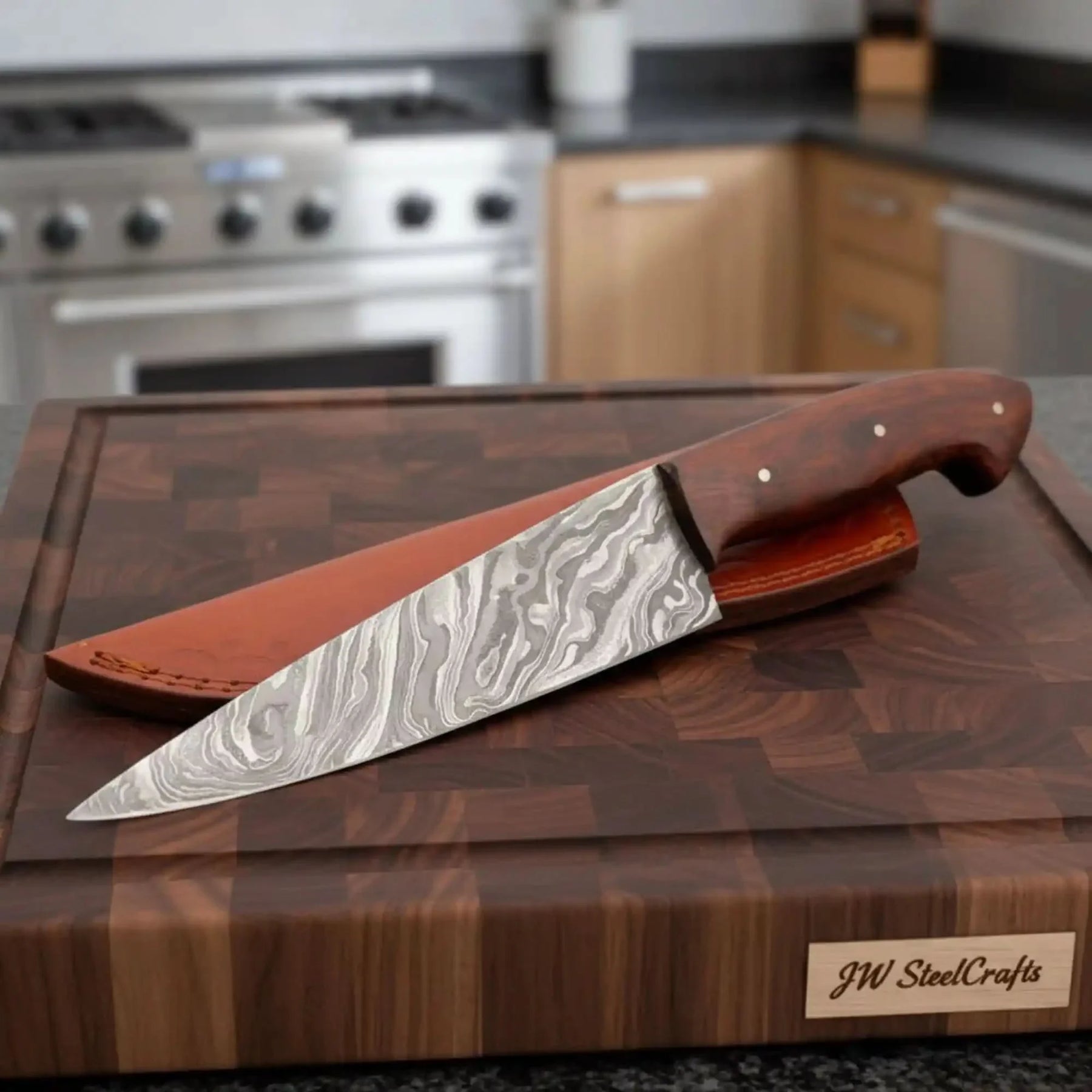 Handmade damascus steel knife with wood handle on dark surface