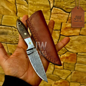 Handmade damascus steel knife with premium handle on dark surface