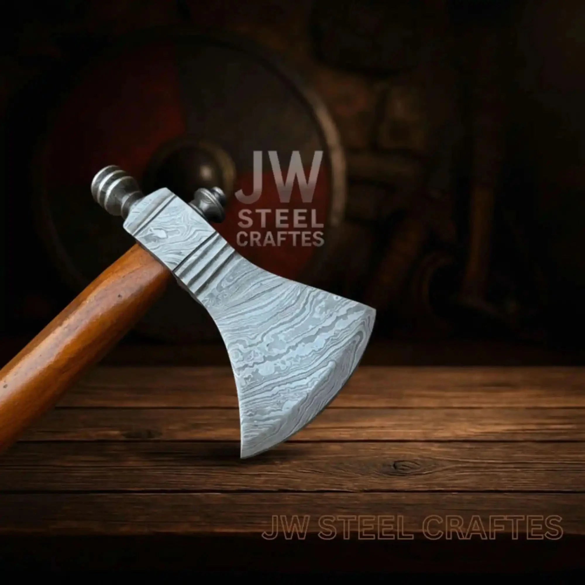 Damascus steel axe head with premium handle on rustic wood surface