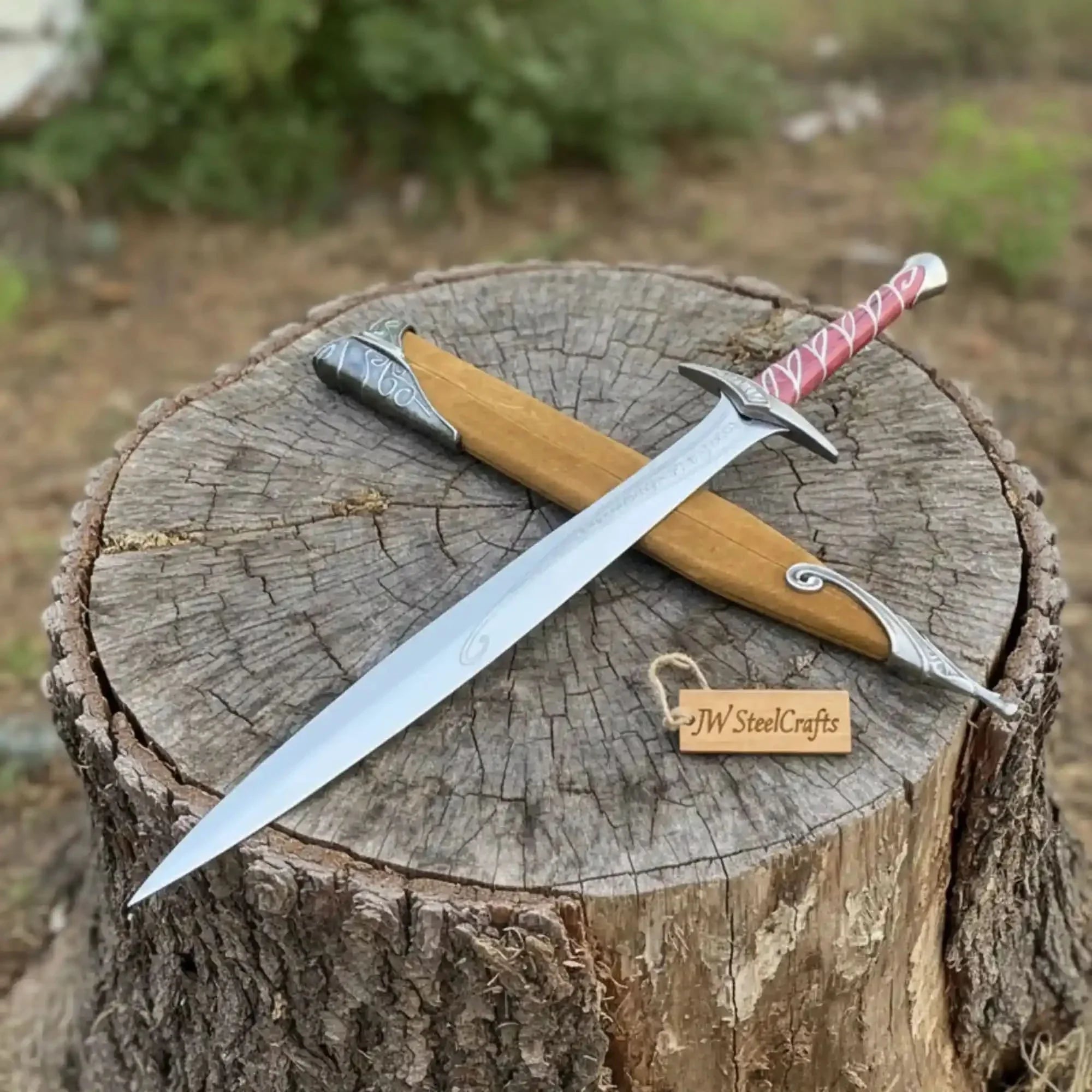 Full-length damascus steel replica sword with wood handle on dark background