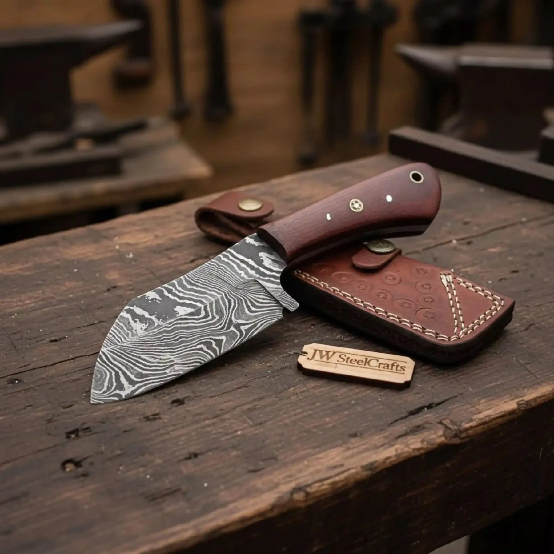 Handmade damascus steel knife with micarta handle on dark surface