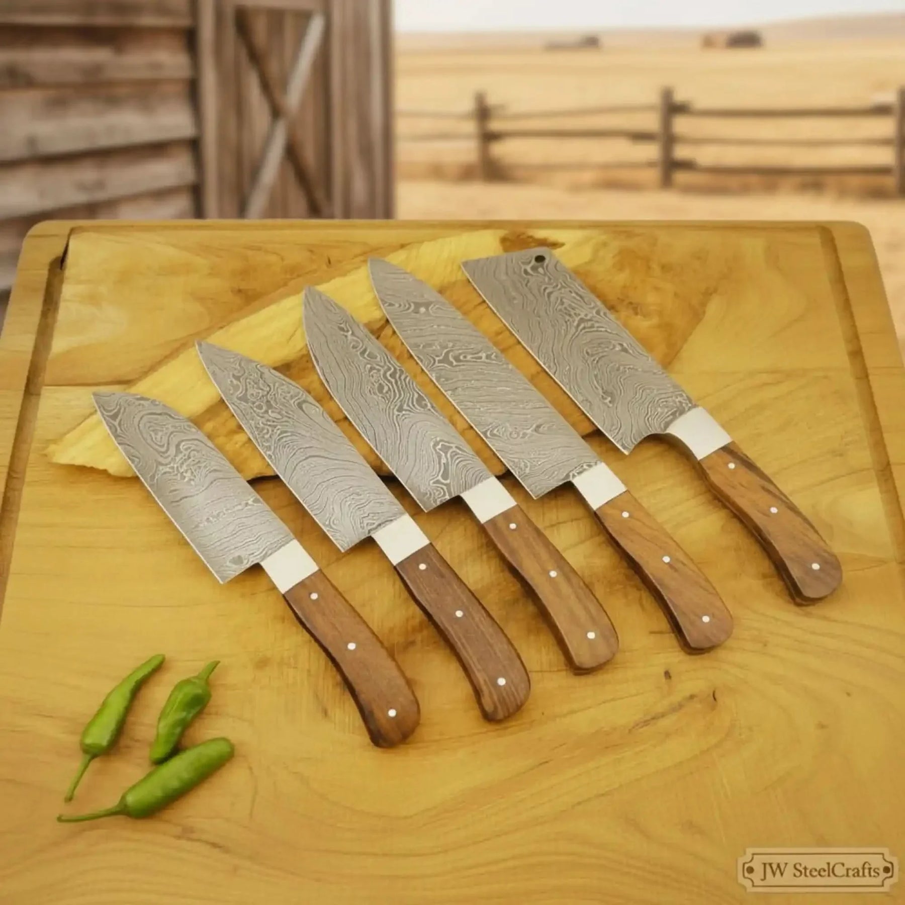 Handmade damascus steel knife with wood handle on dark surface