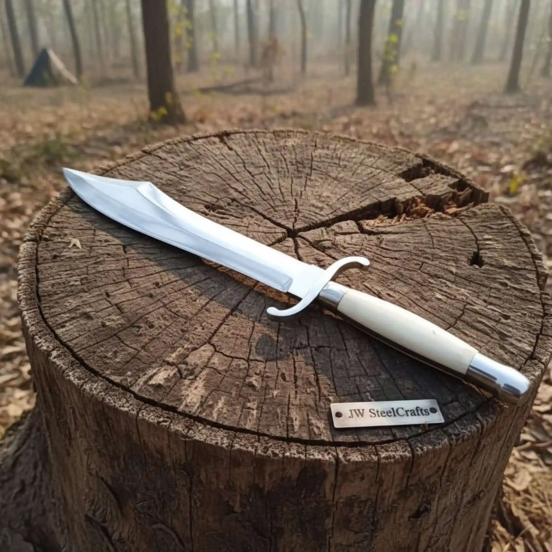 Handmade damascus steel knife with premium handle on dark surface