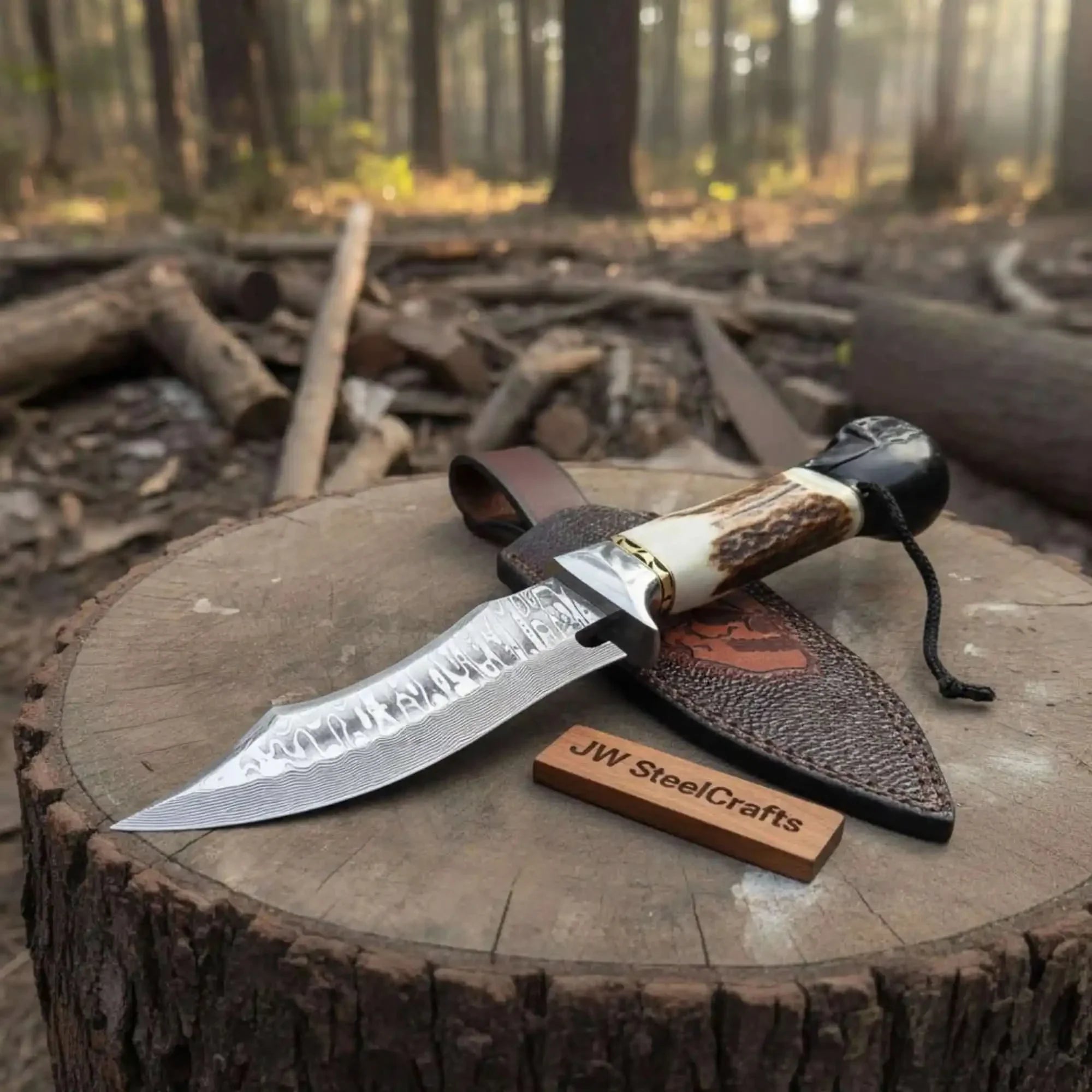 Handmade damascus steel knife with leather handle on dark surface