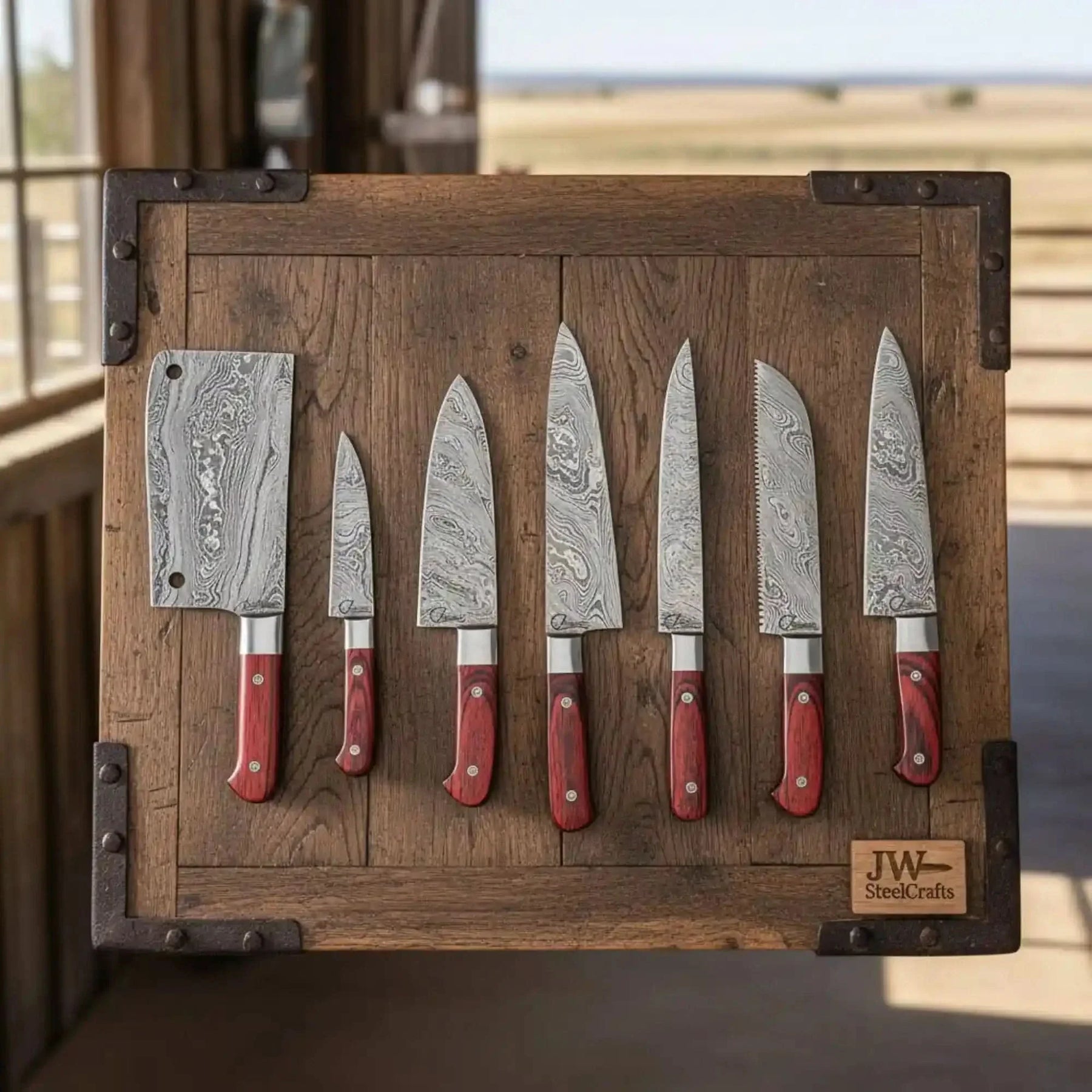 Handmade damascus steel knife with wood handle on dark surface