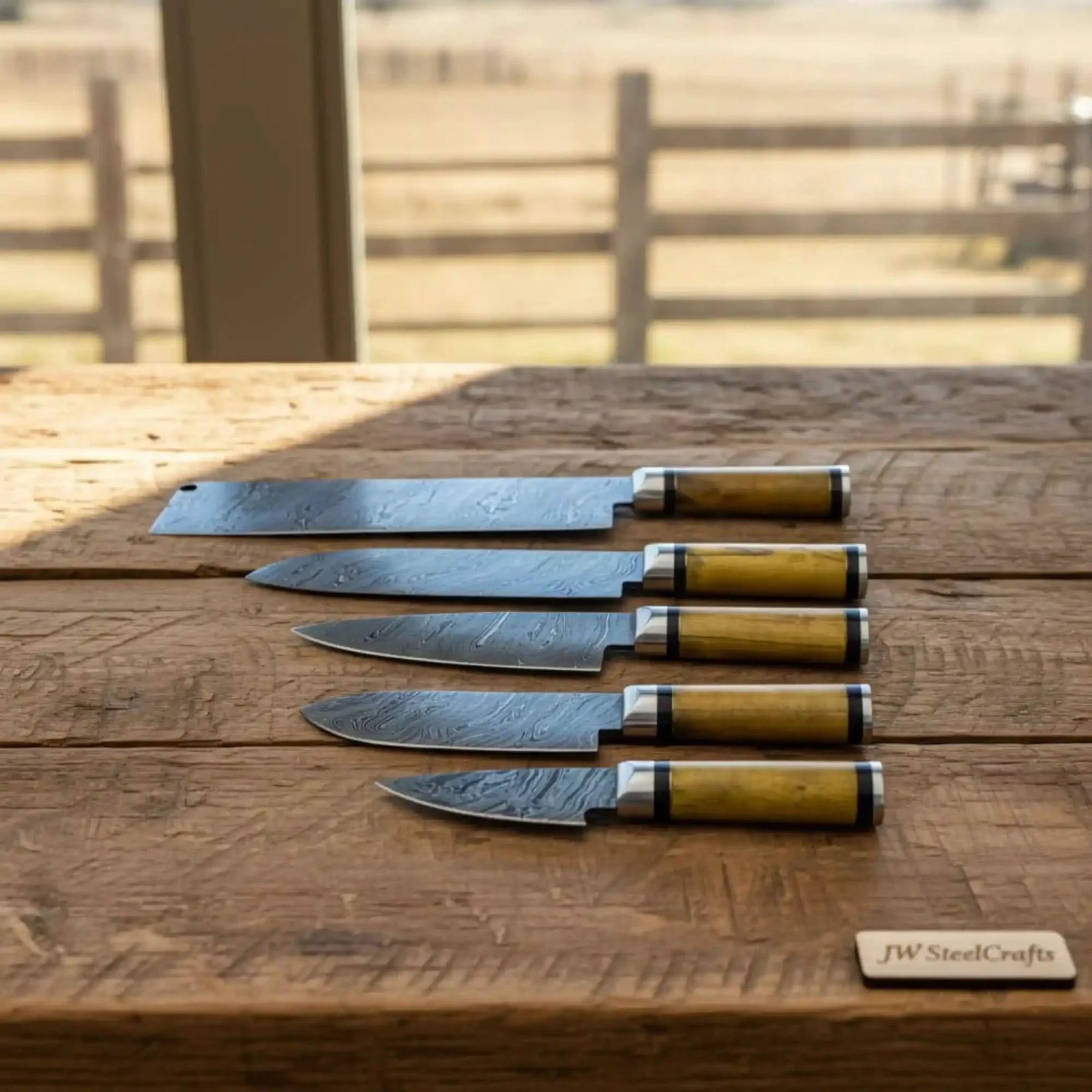 Handmade damascus steel knife with wood handle on dark surface
