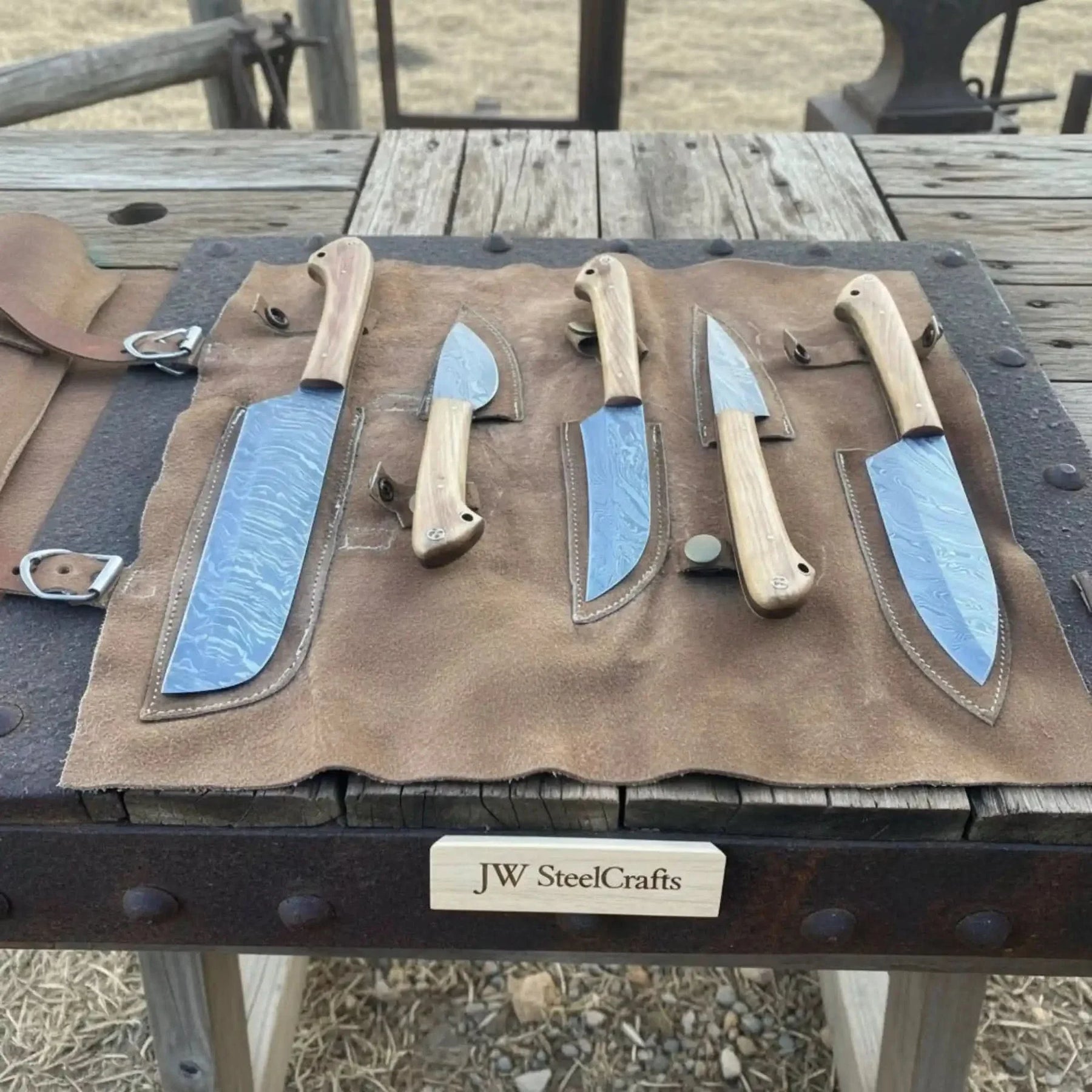Handmade damascus steel knife with wood handle on dark surface