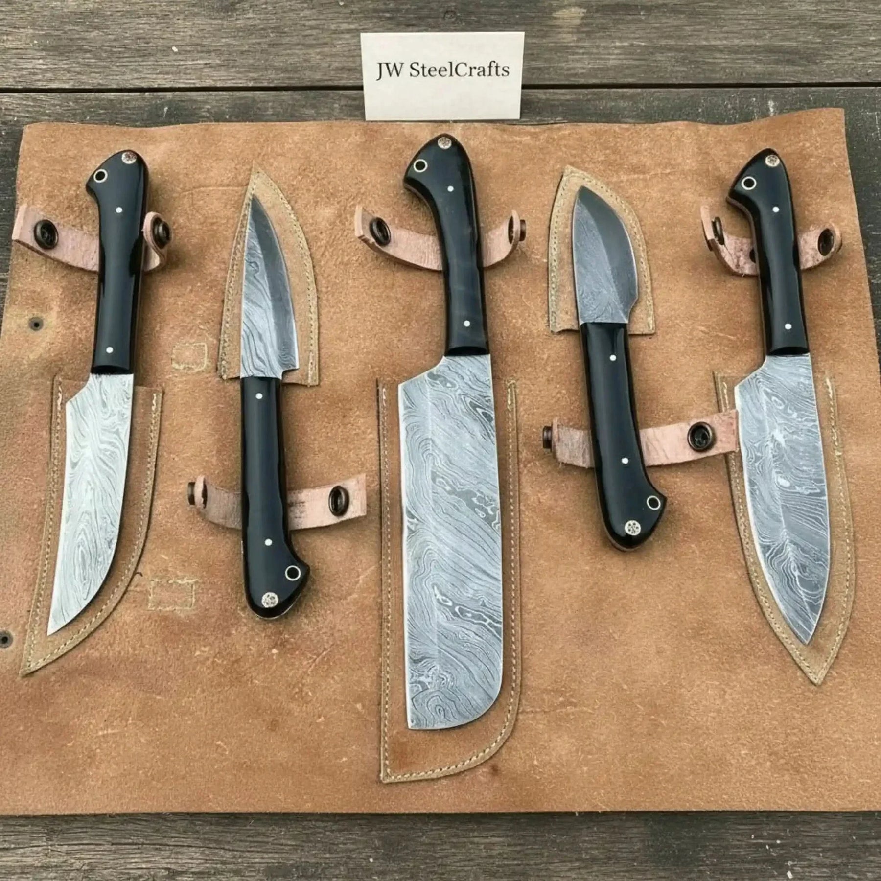 Handmade damascus steel knife with premium handle on dark surface