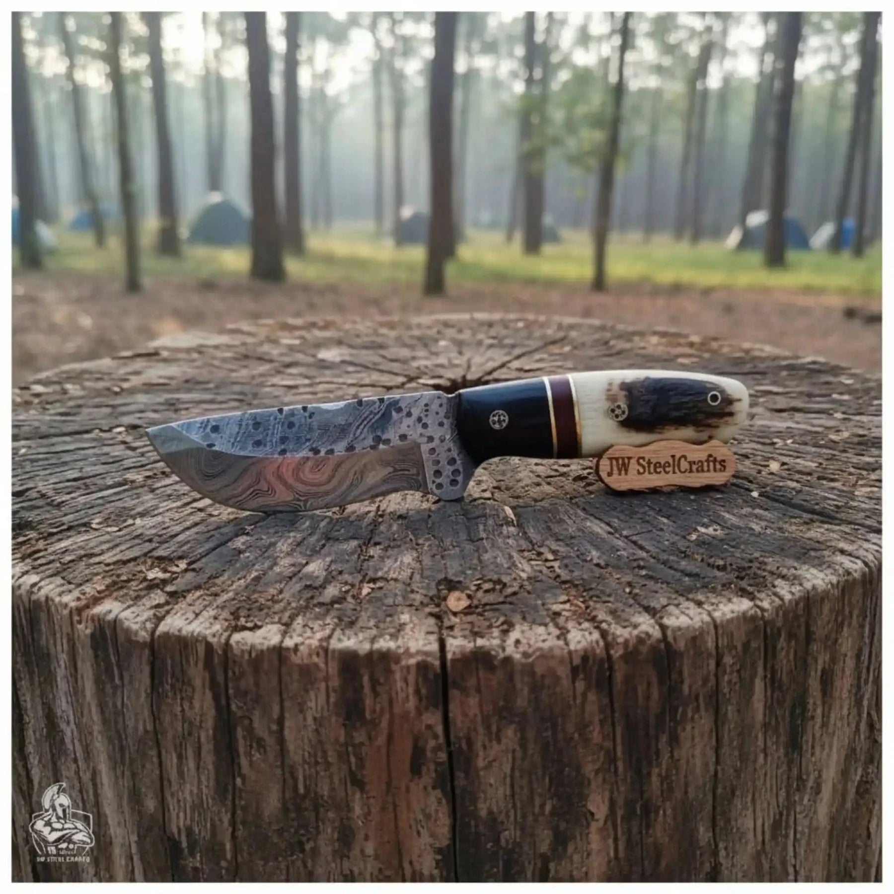 Handmade damascus steel knife with horn handle on dark surface