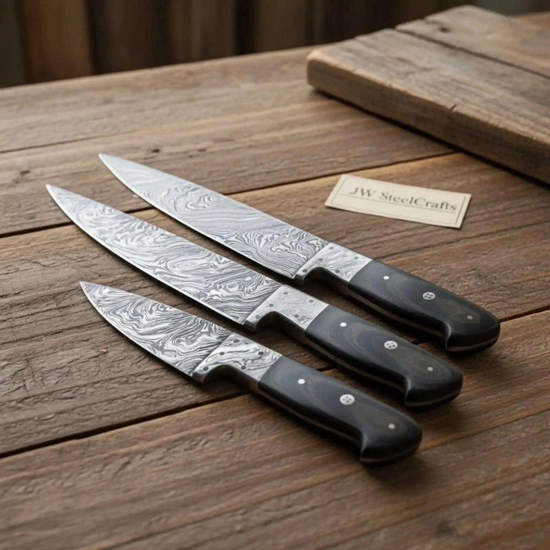Handmade damascus steel knife with wood handle on dark surface