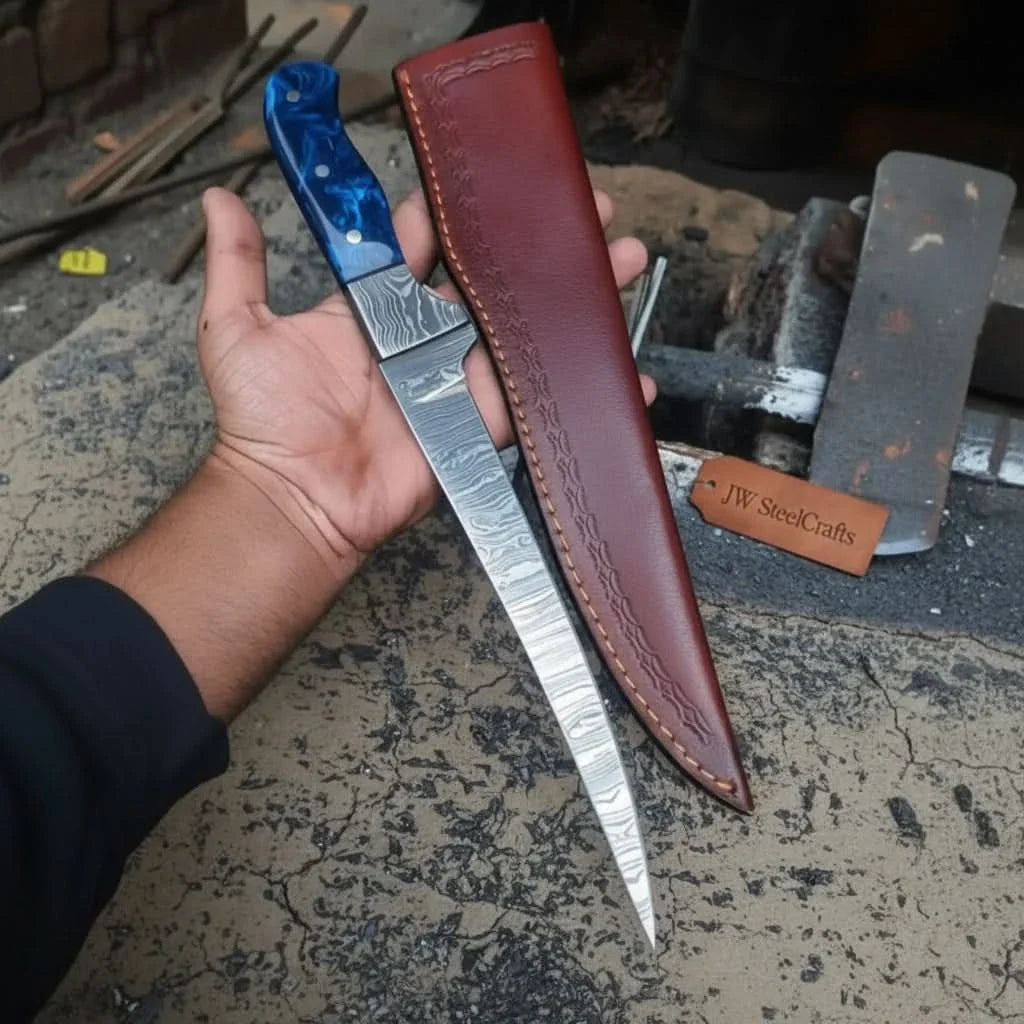 Handmade damascus steel knife with resin handle on dark surface