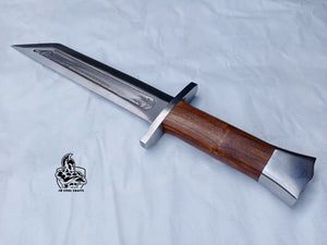 Handmade damascus steel knife with wood handle on dark surface
