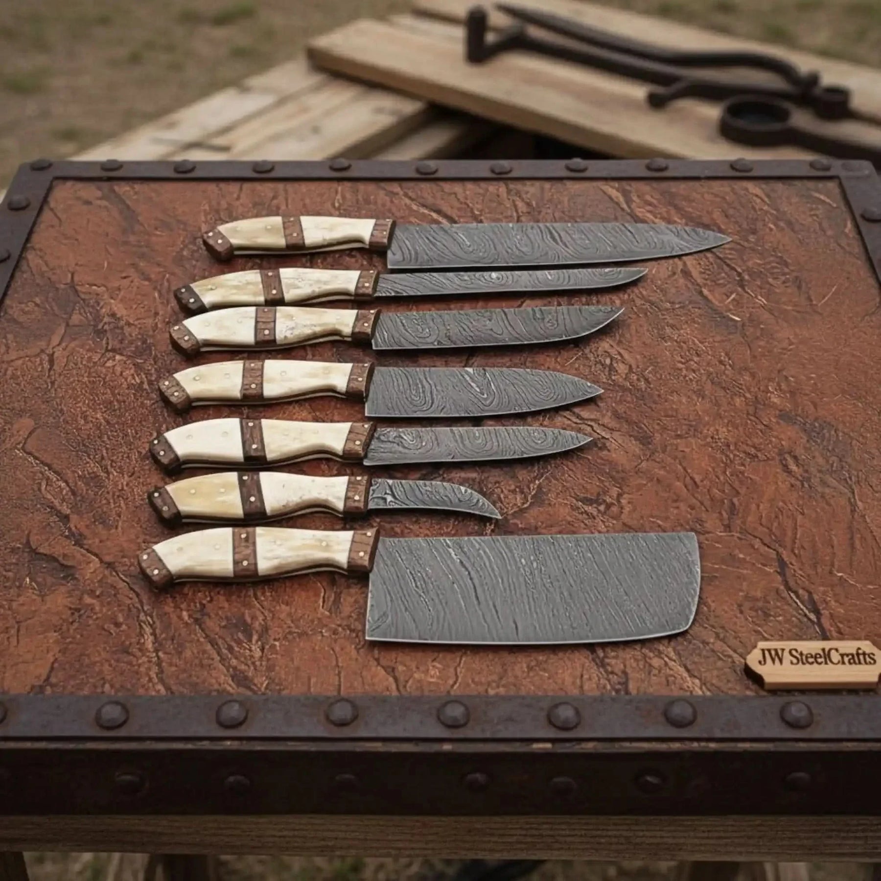 Handmade damascus steel knife with premium handle on dark surface