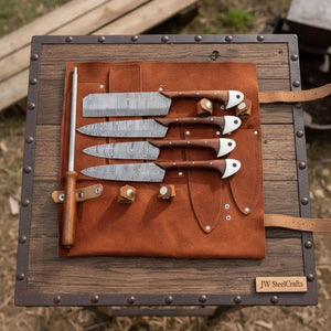 Handmade damascus steel knife with wood handle on dark surface