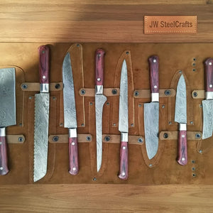 Handmade damascus steel knife with wood handle on dark surface