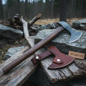 Damascus steel axe head with wood handle on rustic wood surface