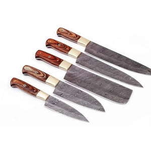 Handmade damascus steel knife with wood handle on dark surface