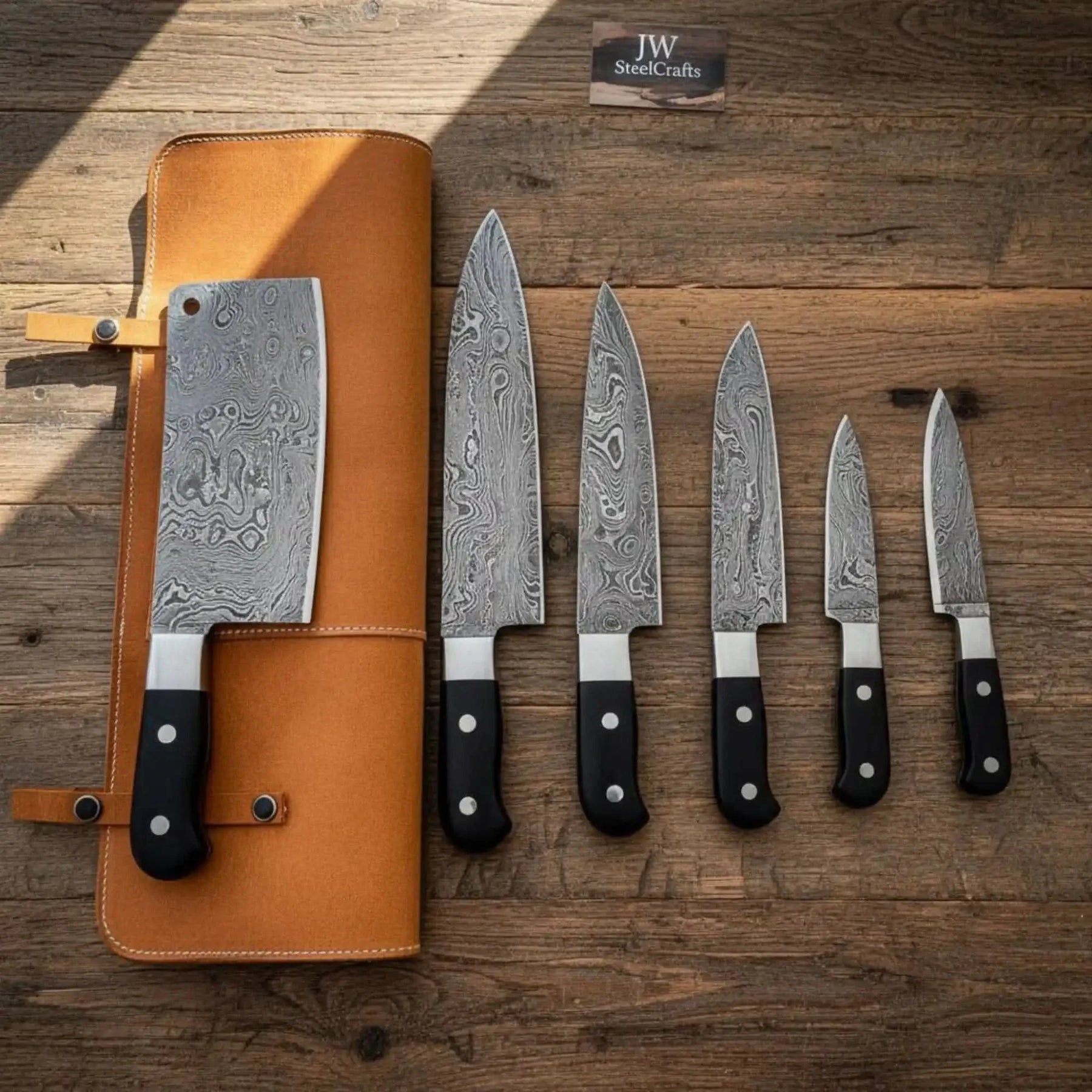 Handmade damascus steel knife with leather handle on dark surface