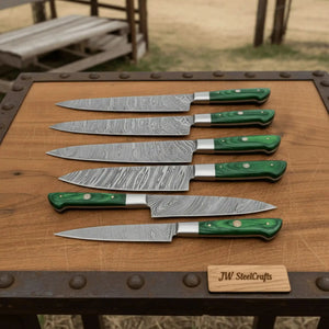 Handmade damascus steel knife with wood handle on dark surface
