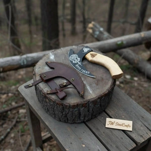 Damascus steel axe head with wood handle on rustic wood surface