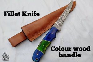 Handmade damascus steel knife with wood handle on dark surface
