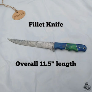 Handmade damascus steel knife with wood handle on dark surface
