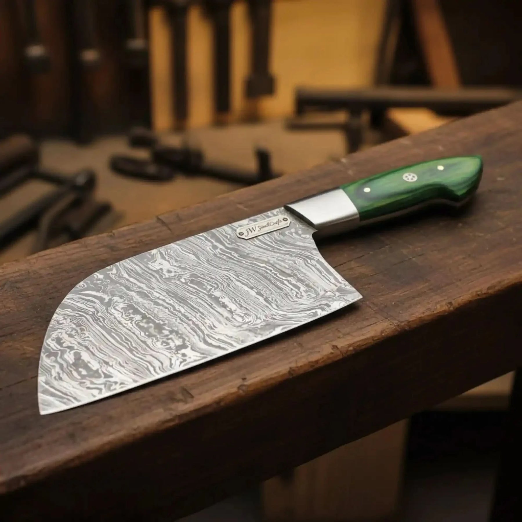 Handmade damascus steel knife with wood handle on dark surface