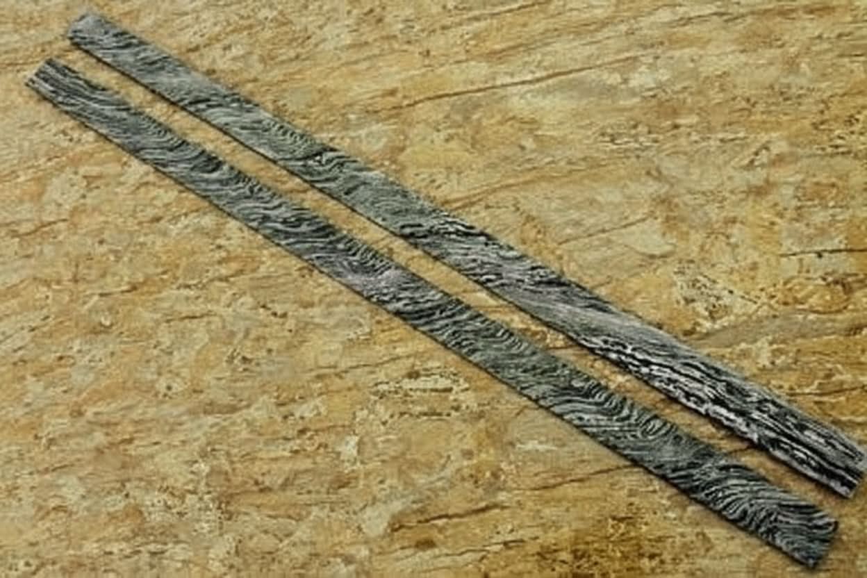 Handmade damascus steel knife with premium handle on dark surface