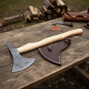 Damascus steel axe head with wood handle on rustic wood surface