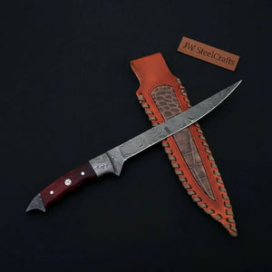 Handmade damascus steel knife with wood handle on dark surface
