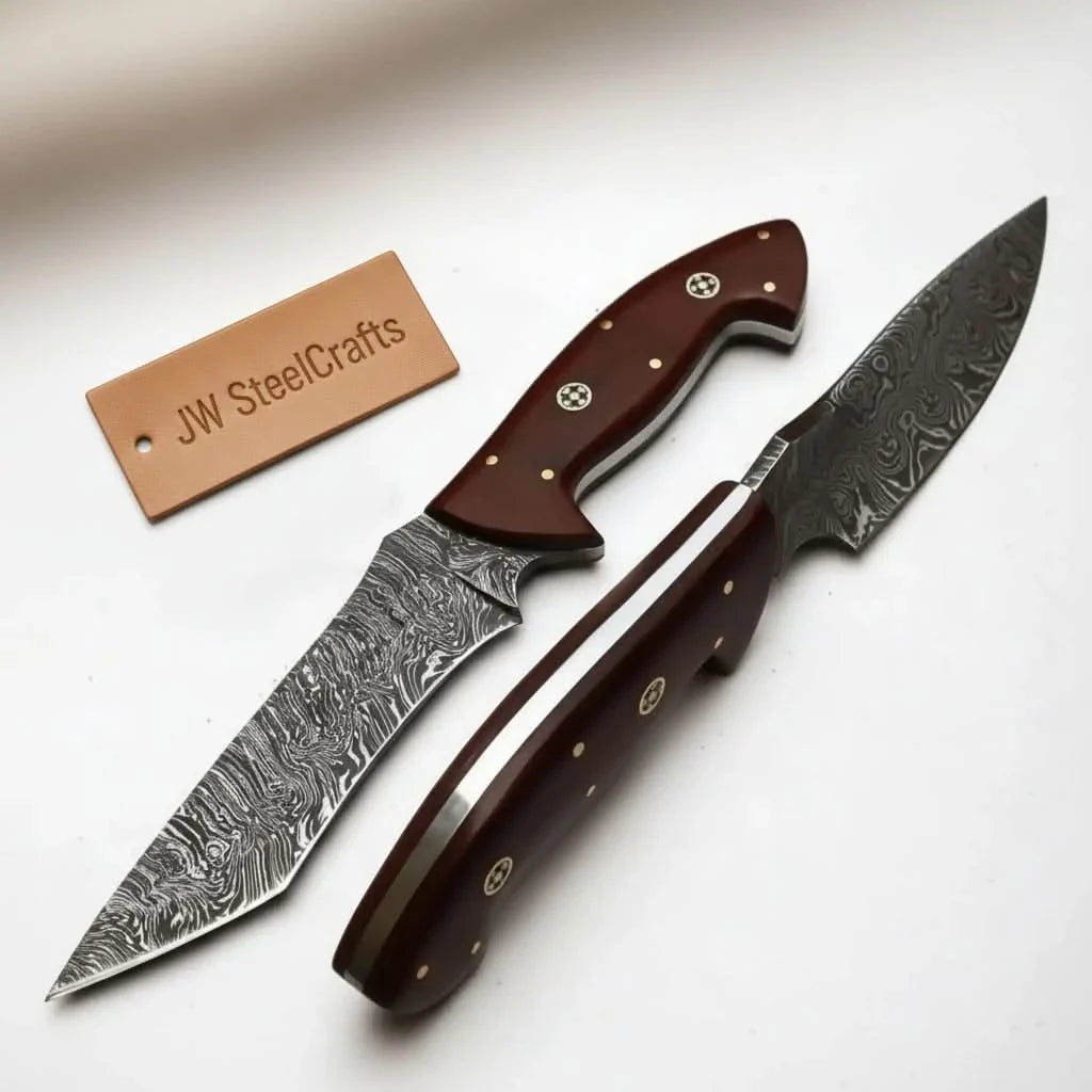 Handmade damascus steel knife with premium handle on dark surface