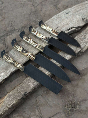 Handmade damascus steel knife with premium handle on dark surface