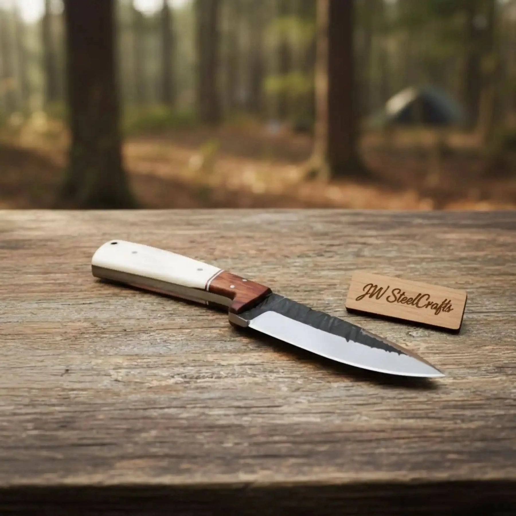 Handmade carbon steel steel knife with wood handle on dark surface