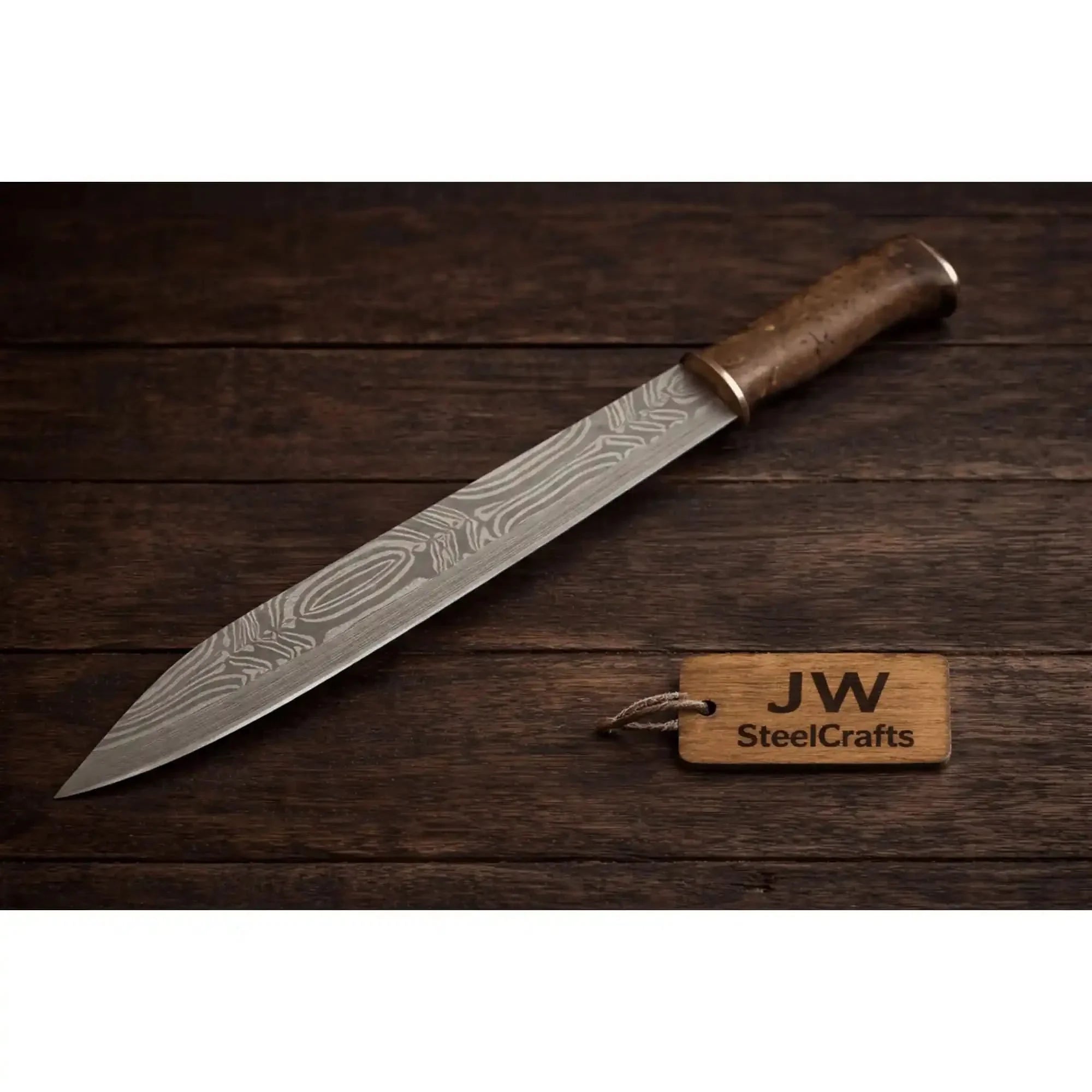 Handmade damascus steel knife with premium handle on dark surface