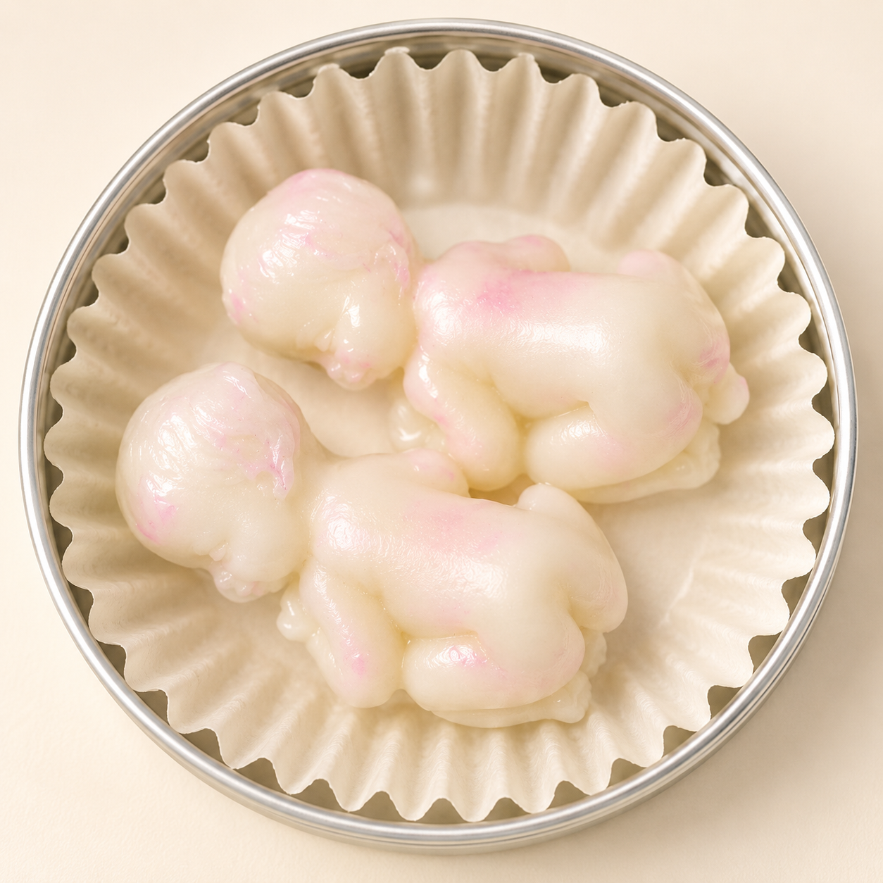 Little Baby Lotion Bars in a polished open tin with three baby shaped solid lotion bars