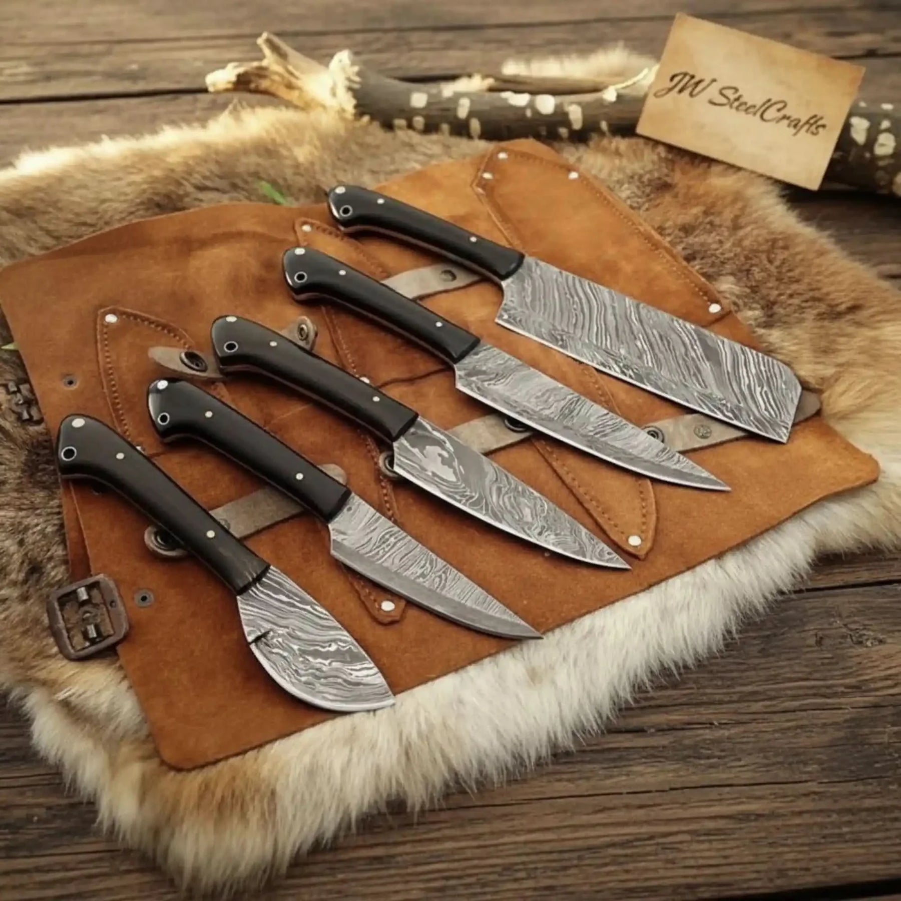 Handmade damascus steel knife with wood handle on dark surface